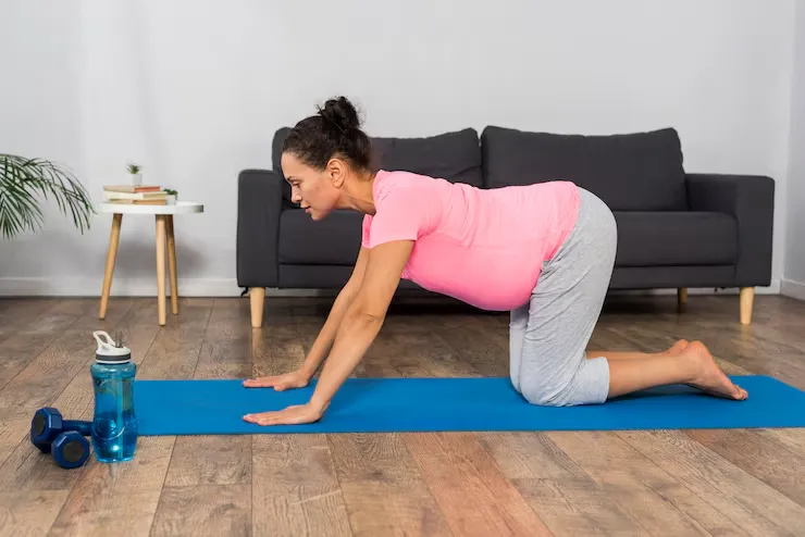 Gentle hands-and-knees spinal movement for pregnancy back discomfort